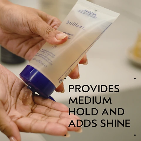 Image 2 - A persons hand dispenses Aveda Brilliant Detexturing Gel into their palm, with the visible text AVEDA, brilliant. DETEXTURING GEL, and PROVIDES MEDIUM HOLD AND ADDS SHINE. Image 3 - A dark green background with a central white circular area featuring pink flower petals, a white jasmine flower, and dark brown cloves. Text reads Blissful Pure-Fume Aroma, and below that, An aromatic blend with jasmine, rose, certified organic clove and other pure flower and plant essences. Image 4 - A split image shows a woman with dark, voluminous curly hair on the left labeled BEFORE Unwashed Hair, and the same woman with sleek, straight dark hair parted down the middle on the right labeled AFTER, with accompanying text Results with Brilliant Shampoo, Conditioner, Damage Control Retexturing Gel, Anti-Humectant Pomade and Medium Hold Hair Spray and Smooth Infusion™ Perfectly Sleek Styling Crème. Blow dried with brush. Image 5 - A four-step hair care routine guide on a dark green background features four circular photos showing hands shampooing dark hair, hands squeezing conditioner from a tube, a person spraying product on long dark hair, and a collection of styling products, with accompanying text: How To Use, 01 Cleanse Brilliant Shampoo, 02 Condition Brilliant Conditioner, 03 Prep Brilliant Damage Control, 04 Style Brilliant Retexturing Gel, Humectant Pomade and Hair Spray. Image 6 - A split image shows a woman with dark curly hair and a white turtleneck; on the left, her hair is frizzy and undefined, captioned BEFORE Unwashed Hair, while on the right, her hair is well-defined and moisturized, captioned AFTER Results with Brilliant Shampoo, Conditioner, Damage Control, Retexturing Gel, Humectant Pomade, Hair Spray, and Wooden Paddle Brush. Blow dried with diffuser attachment. Image 7 - A translucent, slightly yellowish liquid droplet with numerous small air bubbles, set against a white background. Image 8 - Three white certification logos are displayed against a dark green leafy background, reading 100% VEGAN, Certified B Corporation, and Cruelty Free INTERNATIONAL.