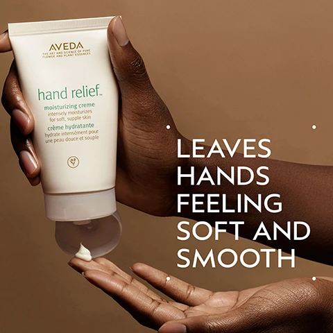 Image 2 - A person with dark skin holds a tube of Aveda Hand Relief moisturizing creme, squeezing a dollop onto their finger, with visible text on the tube and image reading Aveda THE ART AND SCIENCE OF PURE FLOWER AND PLANT ESSENCES hand relief™ moisturizing creme intensely moisturizes for soft, supple skin crème hydratante hydrate intensément pour une peau douce et souple LEAVES HANDS FEELING SOFT AND SMOOTH. Image 3 - A dark green background features a central circular abstract design in shades of green and teal, with white text at the top saying ANDRIOBA OIL and at the bottom saying HELPS PROVIDE SKIN WITH LONG-LASTING NOURISHMENT AND MOISTURE. Image 4 - A close-up shot of a thick, glossy, light yellow cream swirled on a white background. Image 5 - A graphic illustrating two steps for hand care: the top section shows a hand dispensing Aveda Hand Relief Renewal Serum from a pump bottle, and the bottom section shows a hand dispensing Aveda Hand Relief Moisturizing Crème from a squeeze tube, with the visible text How to use, 01 Treat, Hand Relief™ Renewal Serum, 02 Moisturize, Hand Relief™ Moisturizing Crème, AVEDA THE ART AND SCIENCE OF PURE FLOWER AND PLANT ESSENCES. Hand Relief Renewal Serum, AVEDA THE ART AND SCIENCE OF PURE FLOWER AND PLANT ESSENCES. hand relief™ moisturizing creme intensely moisturizes for soft, supple skin crème hydratante hydrate intensément pour une peau douce et souple. Image 6 - Three certification logos are displayed against a background of green plant leaves and a red stem: 100% Vegan, Certified B Corporation, and Cruelty Free International.