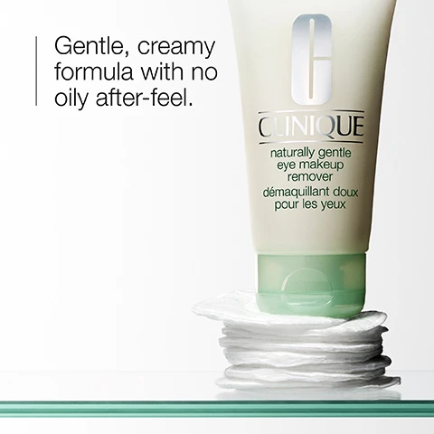 Image 1 - A tube of Clinique naturally gentle eye makeup remover sits on a stack of cotton pads, with the text reading Gentle, creamy formula with no oily after-feel.
Image 2 - A smear of white cream is shown against a plain background, with the text dissolve eye makeup prominently displayed next to it.
Image 3 - A close-up of a clear glass object beside a light green striped background, showing a list with check marks indicating it is free of fragrance, gluten, sodium lauryl sulfate, and sodium laureth sulfate.