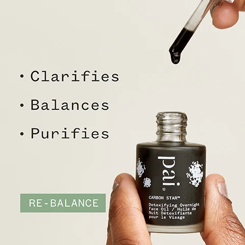 Image 1 - A hand holds a dark glass bottle labeled pai CARBON STAR™ Detoxifying Overnight Face Oil with a dropper dispensing oil above it, next to bullet points reading Clarifies, Balances, Purifies, and a green box stating RE-BALANCE.
Image 2 - An individual is holding a dropper bottle labeled pai Carbon Star Detoxifying Overnight Face Oil while showing a shoulder with clear skin, accompanied by the text 76% said skin looked clearer* and various certification logos.