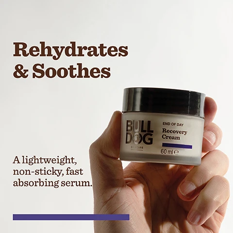 Image 2 - A person is holding a jar of Bulldog Skincare Recovery Cream, with visible text stating Rehydrates & Soothes and END OF DAY Recovery Cream 60 ml A lightweight, non-sticky, fast absorbing serum.
Image 3 - A container of Bulldog Skincare Recovery Cream is placed next to dark grapes, with visible text listing ingredients: +Melatonin +Tiger Grass Extract +Shea Butter.
Image 4 - A purple background features a white illustration of a jar and lid, with text detailing the jar made of 50% PCR plastic, the lid made of 30% PCR plastic, and the statement that the packaging is an FSC certified cardboard carton, alongside icons indicating 98% natural origin, natural origin fragrance, and a vegan approval logo.
Image 5 - Image of several skincare products from Bulldog Skincare, including a tube of Recovery Cleansing Face Gel, a box of Recovery Serum, a jar of Recovery Cream, and a bottle of Recovery Serum, all prominently displaying the Bulldog brand logo and text explaining their uses. Visible text includes Restore + Recover.