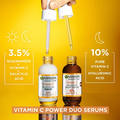 Image 1 - Two serum bottles by Garnier are pictured on a bright yellow background; the left bottle is labeled with 3.5% Niacinamide + Vitamin C + Salicylic Acid and the right bottle is labeled with 10% Pure Vitamin C + Hyaluronic Acid, with the text VITAMIN C POWER DUO SERUMS displayed below them.
Image 2 - A woman with smooth skin holds two droppers with a yellow-orange background, conveying a skincare message that highlights the products ability to fight dark spots day and night. FIGHTS THE APPEARANCE OF DARK SPOTS DAY & NIGHT.
Image 3 - Two women pose for a photo, one with short blonde hair holding a serum bottle and the other with long dark hair also holding a serum, with the text BRIGHTENING POWER DUO SERUMS DOUBLE THE VITAMIN C POWER prominently displayed above and below them.
Image 4 - An image of two Garnier serum bottles on a bright yellow background, with text stating 8/10 agree its the best serum theyve ever used, and logos indicating cruelty-free and vegan formulas.
Image 5 - A close-up of a woman applying a dropper of serum to her cheek, with text on the image that reads HOW TO USE? and instructions for use: USE 1 FULL PIPETTE, APPLY ON CLEAN SKIN, MASSAGE GENTLY.
Image 6 - Image features two serum bottles labeled Garnier Skin Active Vitamin C with a brown bottle for nighttime serum and a white bottle for daytime serum; text highlights that Garnier products are cruelty-free, vegan, and that the bottles are made from 25% recycled glass.
