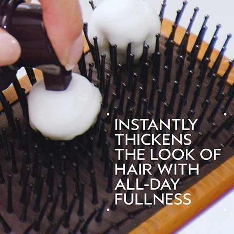 Image 2 - A hand dispenses white foam from a dark brown bottle onto the black bristles of a wooden hairbrush, with the text Instantly Thickens The Look Of Hair With All-Day Fullness. Image 3 - A split image shows a womans face with a side-by-side comparison of her hair: on the left, labeled BEFORE, her hair appears duller and is described as Unwashed Hair; on the right, labeled AFTER, her hair is shinier and fuller, with text indicating Results with botanical repair™ strengthening shampoo, intensive strengthening masque: rich and strengthening leave-in treatment. Blow dried with round bristle hair brush. Image 4 - A circular close-up shows a light green translucent substance with bubbles in liquid and a bright diagonal light beam, all against a dark green background, with the text AMLA and AMPLIFIES HAIR. Image 5 - A dark green infographic displays a 4-step hair routine titled How to use, showing images of a person cleansing, revitalizing, fortifying, and styling their hair: 01 Cleanse & Condition Invati Ultra Advanced™ Exfoliating Shampoo and Thickening Conditioner: Light; 02 Revitalize Invati Ultra Advanced™ Revitalizing Scalp Serum; 03 Fortify Invati Ultra Advanced™ Fortifying Leave-In Treatment; 04 Style Invati Ultra Advanced™ Thickening Foam. Image 6 - A side-by-side image shows a woman with blonde hair; on the left, her hair is straight and flat, labeled BEFORE and Unwashed Hair, and on the right, her hair has soft waves and more volume, labeled AFTER, with the accompanying description Results with Cherry Almond Softening Shampoo, Conditioner, and Leave-In Conditioner, Invati Ultra Advanced™ Thickening Foam, Texture Tonic and Woodle Paddle Brush. Blow dried with diffuser attachment and styled with curling iron. Image 8 - Three white certification logos, including a V symbol with 100% VEGAN, a B in a circle with Certified B Corporation, and a leaping rabbit with Cruelty Free International, are displayed against a background of green leaves.