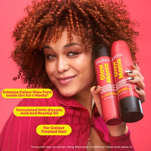 Image 2 - A smiling person with curly hair holds two hair care products against a pink background, with text bubbles reading Enhance Colour Glow From Inside Out For 4 Weeks*, Formulated With Glycolic Acid And Rosehip Oil, and For Colour Treated Hair.
Image 3 - A bright pink bottle labeled Matrix Glow Mania is placed on a light pink creamy background, with visible text stating Creamy, Lightweight Texture, Hair Feels Softer and Looks Shinier, and Vegan Formula, along with a disclaimer about animal-derived ingredients.
Image 4 - Image shows a comparison of hair before and after treatment, with the left side labeled Before and the right side labeled After against a pink background, featuring curly hair with enhanced definition and shine. Visible text at the bottom reads *When Used With A System Of Shampoo, Mask And Leave-In*.
Image 5 - A coconut half with white flesh sits alongside slices of grapefruit and mango, complemented by fresh geranium leaves and flowers, on a bright pink background, with visible text reading Sweet Coconut Water, Juicy Mango, Fresh Geranium, and Sparkling Grapefruit.
Image 6 - A bright pink background features four hair care products from the Glow Mania line, including a shampoo and conditioner, a mask, and a leave-in conditioner, with labels highlighting Steps 1 through 3 and descriptions of their benefits.