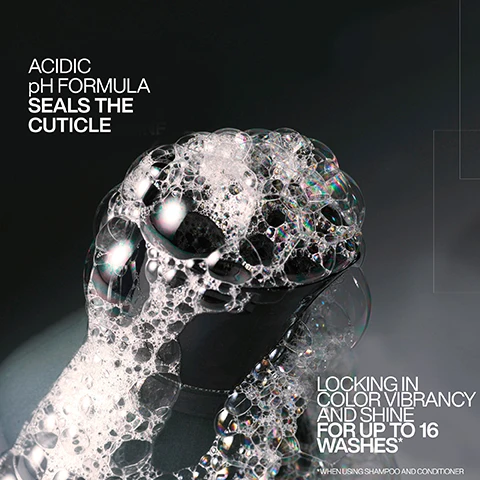 Image 1 - An image of a close-up of a black container with foamy bubbles, featuring text that reads ACIDIC pH FORMULA SEALS THE CUTICLE LOCKING IN COLOR VIBRANCY AND SHINE FOR UP TO 16 WASHES* WHEN USING SHAMPOO AND CONDITIONER.
Image 2 - A black spray bottle labeled REDKEN 5TH AVENUE NYC with the text acidic color gloss heat protection treatment is displayed against a light pink background, featuring phrases INVISIBLE SHIELD TECHNOLOGY, 13X SMOOTHER HAIR, and 230°C HEAT PROTECTION.
Image 3 - Image depicts a woman with wavy, medium-length hair divided into two sections labeled BEFORE and AFTER, with the right side showing enhanced color vibrancy and the text BOOST COLOR VIBRANCY FOR UP TO 16 WASHES USING ACIDIC COLOR GLOSS SHAMPOO & CONDITIONER.
Image 4 - A person with long, wavy red hair is shown from the back, with the left side representing the hairs condition before treatment, which is frizzy and unruly, while the right side shows the after treatment results, which are smooth and wavy; visible text includes BEFORE on the left and AFTER* on the right, along with a note at the bottom that reads *ONE USE OF ACIDIC COLOR GLOSS SYSTEM.
Image 5 - Image showing a step-by-step guide on using Acidic Color Gloss, with four numbered steps; step 1 features a person shampooing hair, step 2 shows a bottle of Redken Acidic Color Gloss with instructions to apply to towel-dried hair for 5 minutes, step 3 depicts conditioner being dispensed from a bottle, and step 4 shows a person spraying leave-in treatment onto damp hair.
Image 6 - The image shows four steps of a hair care routine featuring Redken products: a black bottle labeled acidiC color gloss for cleansing, a bottle for glossing, a bottle for conditioning, and a spray bottle for leave-in and protection, with visible step numbers 1 to 4 and descriptions of each function.
Image 7 - A hand holding a spray bottle is releasing a mist of liquid with the text Leave-In Heat Protectant Spray prominently displayed.
Image 8 - Image shows a side-by-side comparison of hair before and after treatment, with the left side displaying dull hair and the right side showcasing shiny, styled hair; visible text includes Glass-like shine for up to 3-days, before, after, look created using Redken SEQ (Redken salon only service) and Acidic Color Gloss, and @styledbyclairelouise.
Image 9 - A close-up image of a black spray bottle labeled Redken Acidic Color Gloss, featuring promotional text about the products effectiveness for hair care, with a five-star rating and customer testimonial on a light pink background.
Image 10 - A person is washing their hair with shampoo, and visible text in the image states SULFATE-FREE FOR A GENTLE CLEANSE.