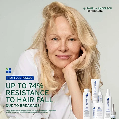 Image 2 - Pamela Anderson, a blonde woman in a white shirt, smiles at the camera with her chin resting on her hand, alongside a collection of white hair care products, with text stating + PAMELA ANDERSON FOR BIOLAGE, NEW FULL RESCUE UP TO 74% RESISTANCE TO HAIR FALL DUE TO BREAKAGE, and a small disclaimer *High repetition, instrumental test. Full Rescue Shampoo, Conditioner and Serum vs. non-conditioning shampoo on bleached hair.